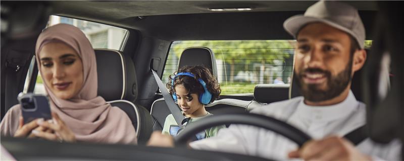 Woman on her phone in her car