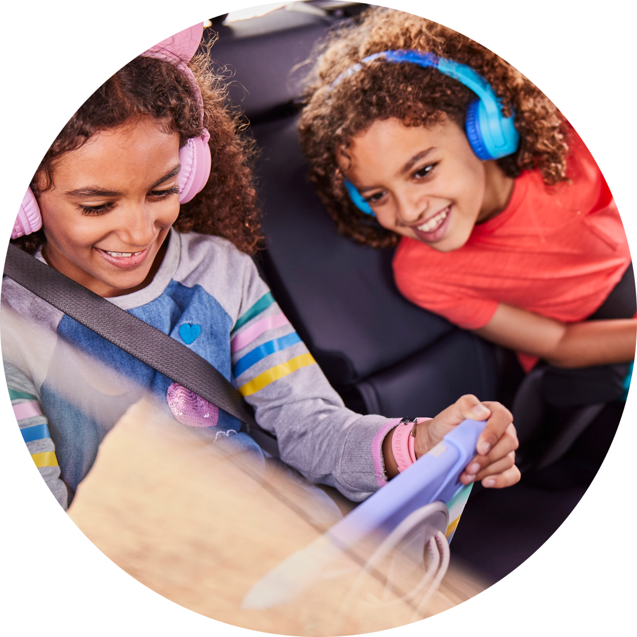 two girls watching the tab inside the car