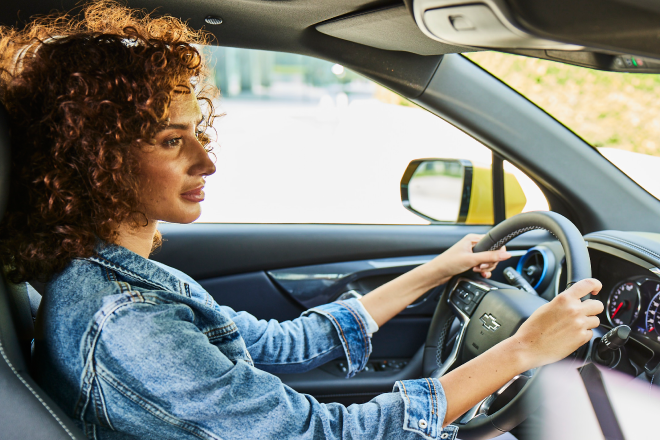 Woman with hands on the steering wheel