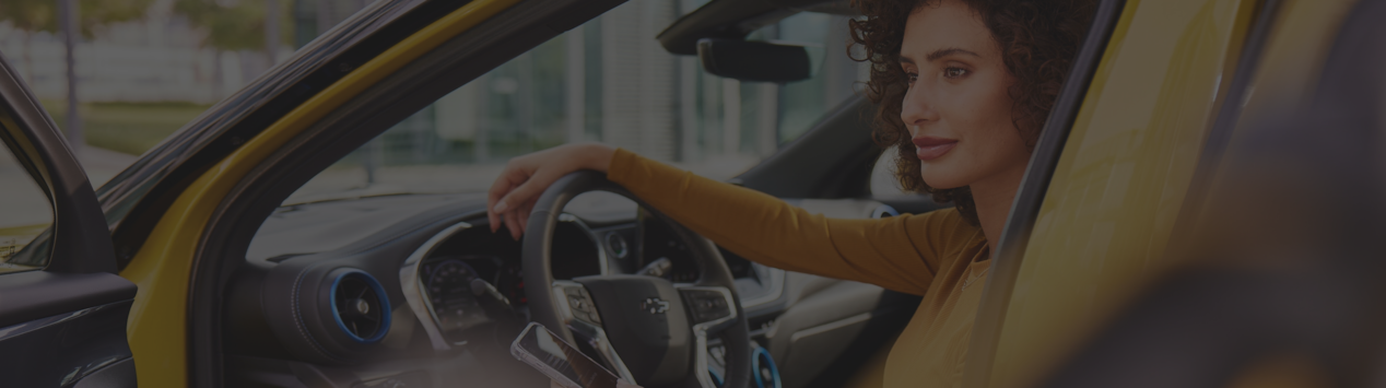 Woman sitting in a car with door open