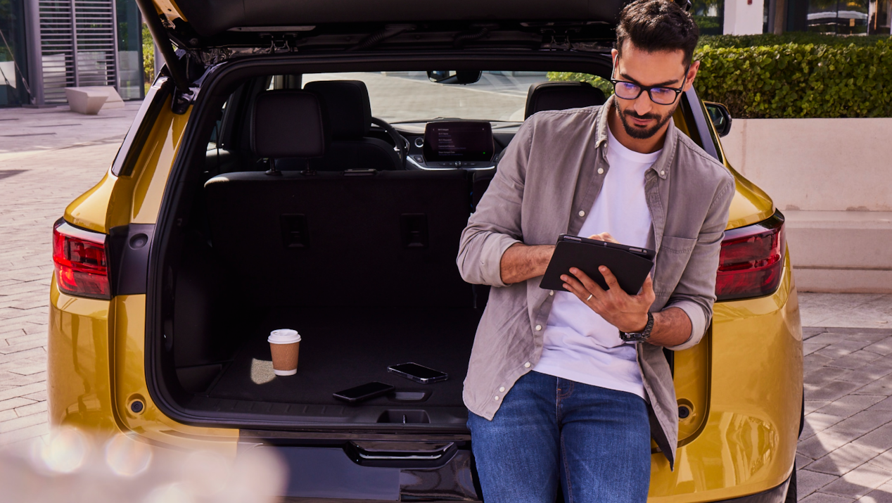 Man on ipad sitting car