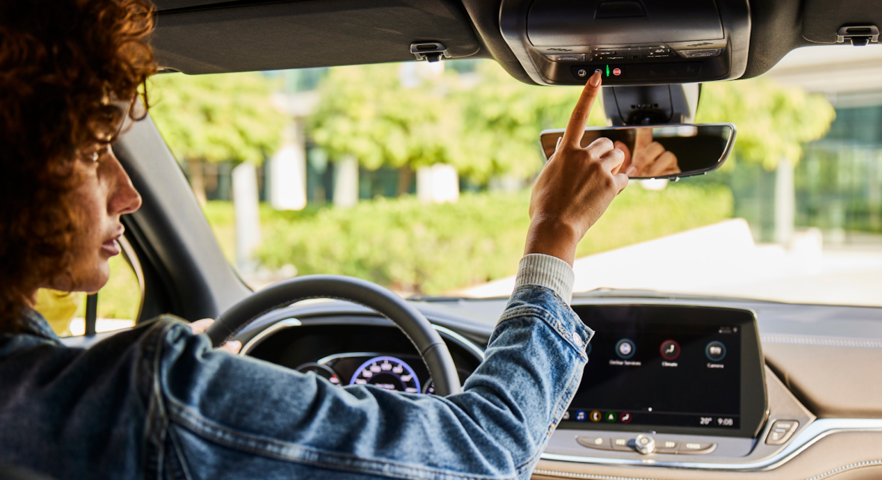 Woman pressing the OnStar button